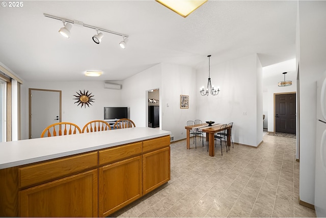 kitchen featuring a wall mounted air conditioner, decorative light fixtures, and a chandelier