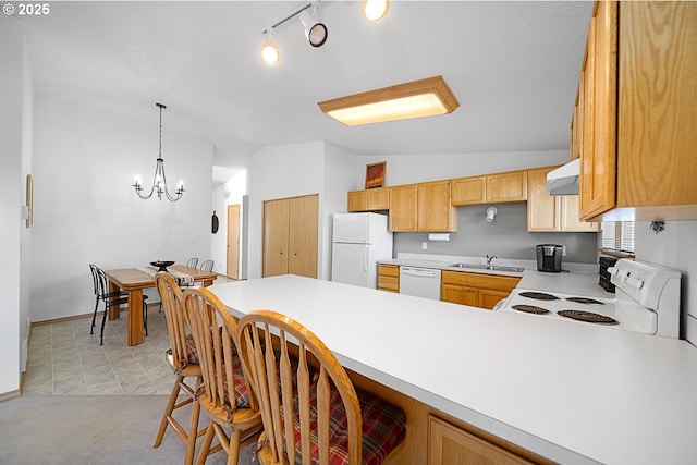 kitchen featuring lofted ceiling, sink, kitchen peninsula, white appliances, and range hood