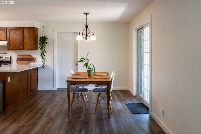 dining room featuring baseboards, dark wood-style floors, and a chandelier