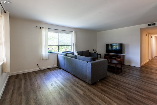 living area with dark wood finished floors and baseboards