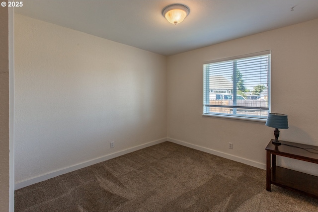 unfurnished room with carpet and baseboards