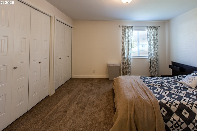 bedroom featuring two closets and carpet floors