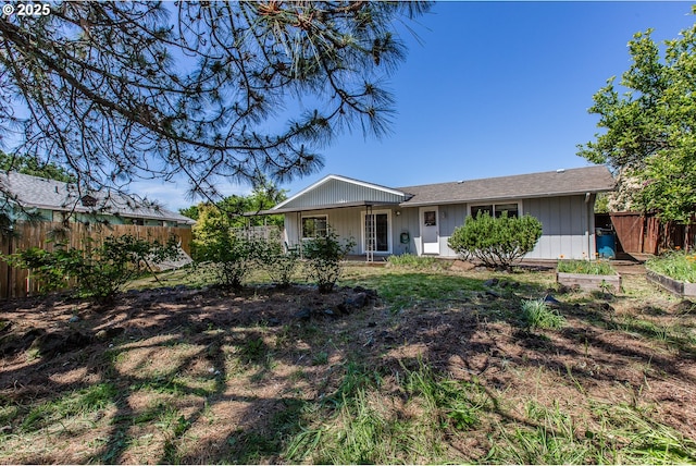 back of property featuring fence and board and batten siding