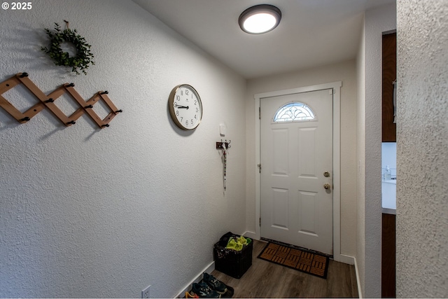 entryway featuring wood finished floors and baseboards