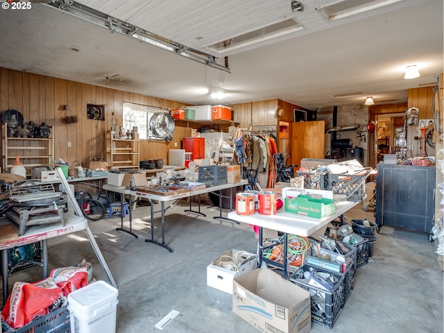 garage featuring a workshop area and wood walls