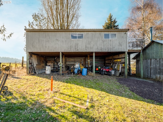 rear view of property with an outdoor structure