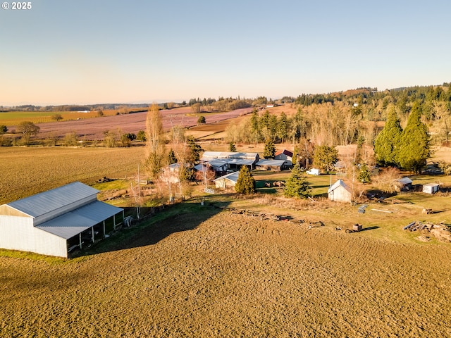 aerial view at dusk featuring a rural view