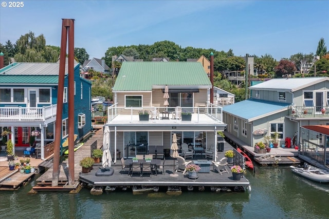 460 N Tomahawk Island Dr, Portland, OR 97217 - rear view of property with a balcony, a water view, a patio area, and a metal roof