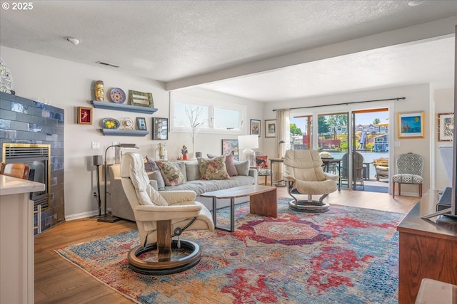 460 N Tomahawk Island Dr, Portland, OR 97217 - living room featuring wood finished floors, a textured ceiling, and beam ceiling