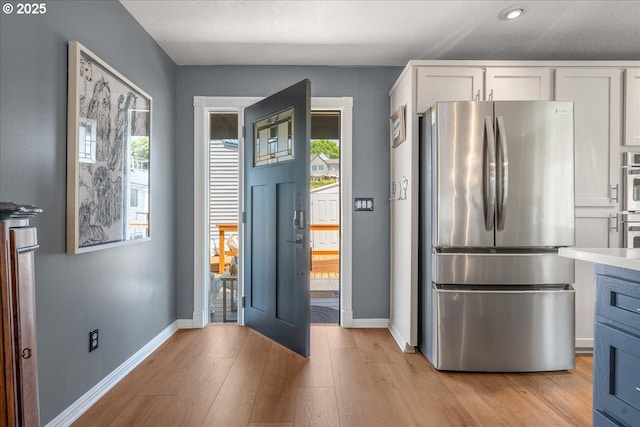 460 N Tomahawk Island Dr, Portland, OR 97217 - kitchen featuring stainless steel appliances, white cabinets, plenty of natural light, and recessed lighting