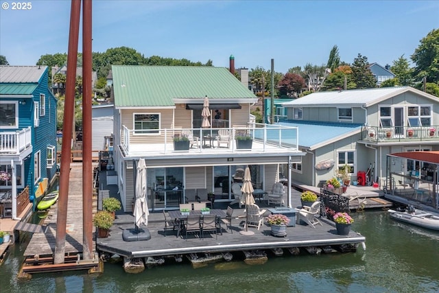460 N Tomahawk Island Dr, Portland, OR 97217 - rear view of property featuring a balcony, a water view, a metal roof, and a patio