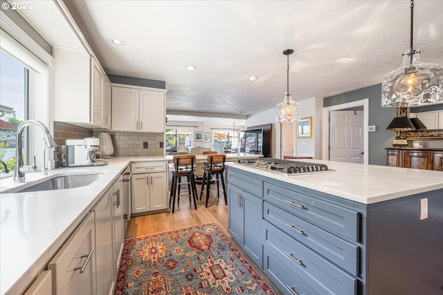 460 N Tomahawk Island Dr, Portland, OR 97217 - kitchen featuring stainless steel gas cooktop, light countertops, light wood-type flooring, recessed lighting, and backsplash