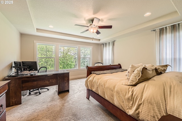 bedroom featuring a raised ceiling, light carpet, an office area, ceiling fan, and recessed lighting