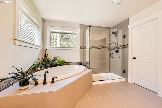 full bath featuring a stall shower, a bath, and tile patterned floors