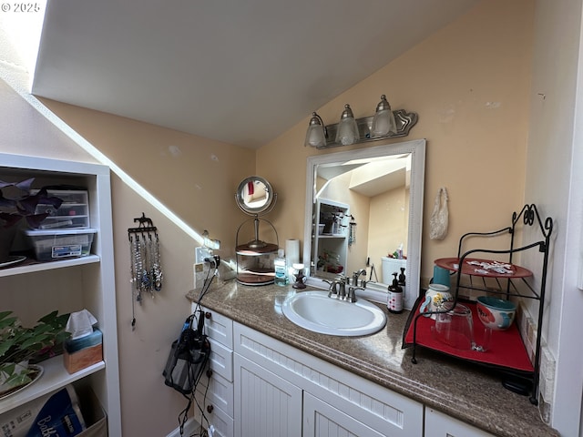 bathroom featuring vanity and lofted ceiling