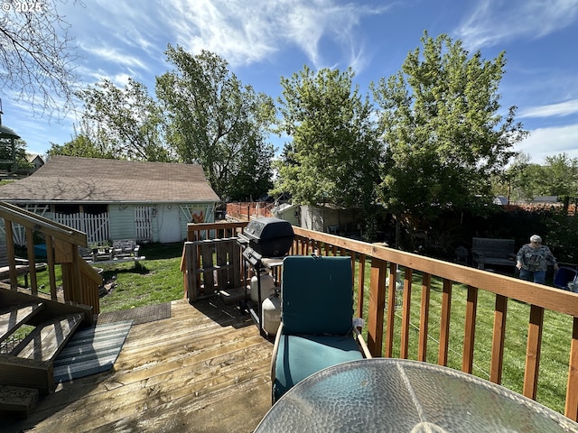 deck with outdoor dining area, a lawn, an outdoor structure, and area for grilling
