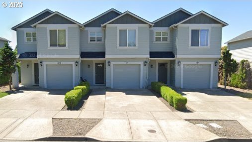 Catron St, Monmouth, OR 97361 - view of front facade featuring a garage and driveway