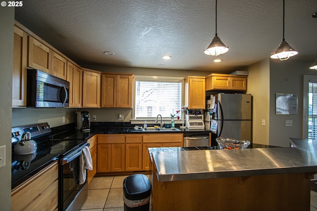 1072 53rd St, Springfield, OR 97478 - kitchen featuring light tile patterned floors, dark countertops, a breakfast bar area, stainless steel appliances, and a sink