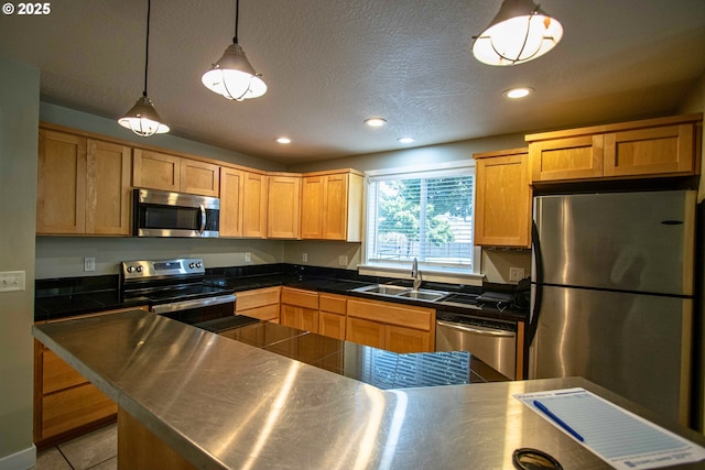 1072 53rd St, Springfield, OR 97478 - kitchen with appliances with stainless steel finishes, a sink, recessed lighting, tile counters, and hanging light fixtures