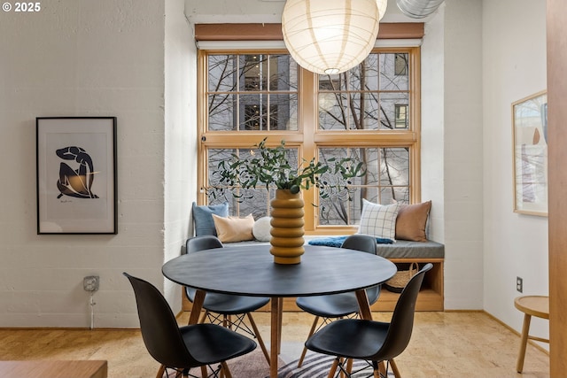 dining room featuring baseboards and breakfast area