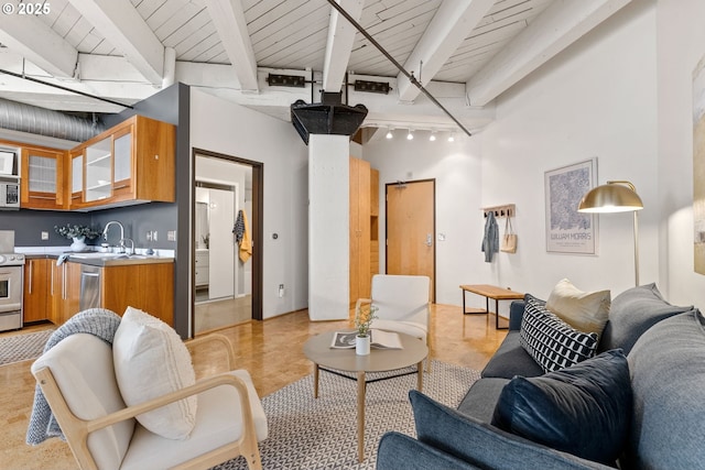 living area featuring wood ceiling, beam ceiling, and track lighting