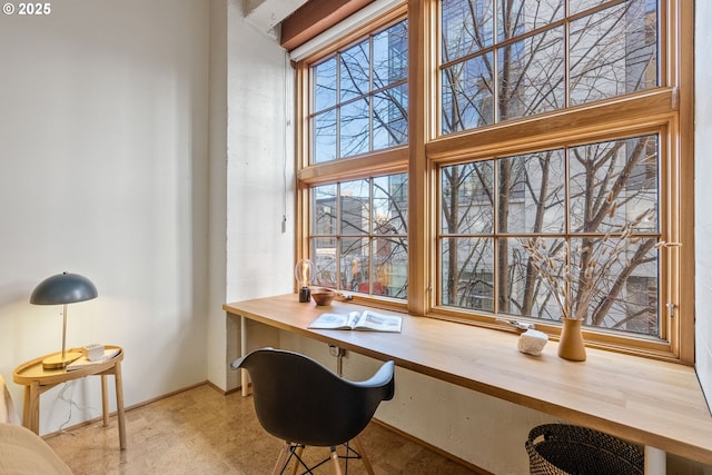 office with built in study area and a towering ceiling