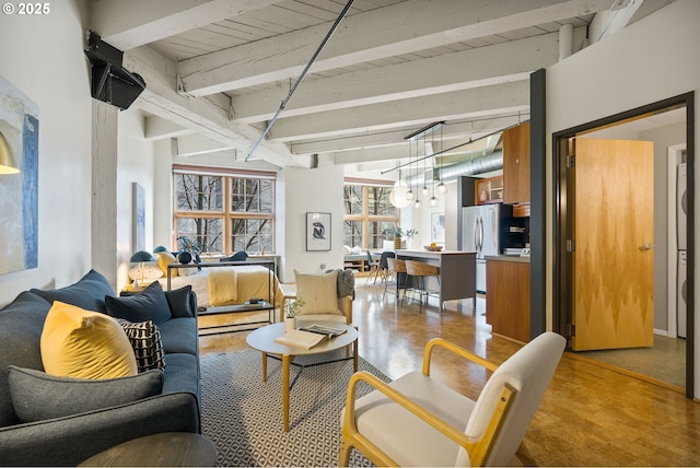 living area featuring concrete floors and beam ceiling