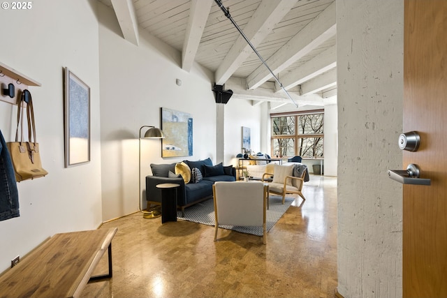 living area with finished concrete floors and beamed ceiling