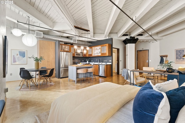 living area with visible vents, finished concrete flooring, and beam ceiling