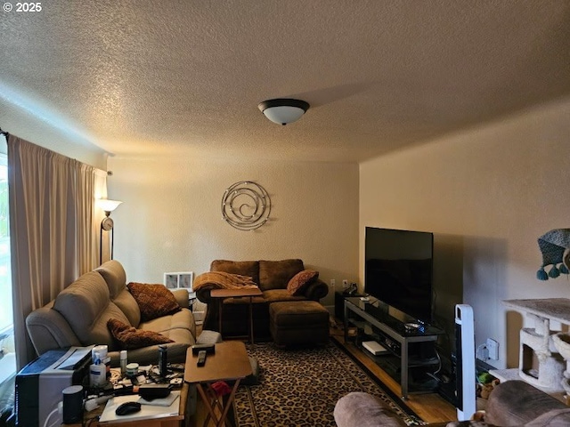 living area with visible vents and a textured ceiling