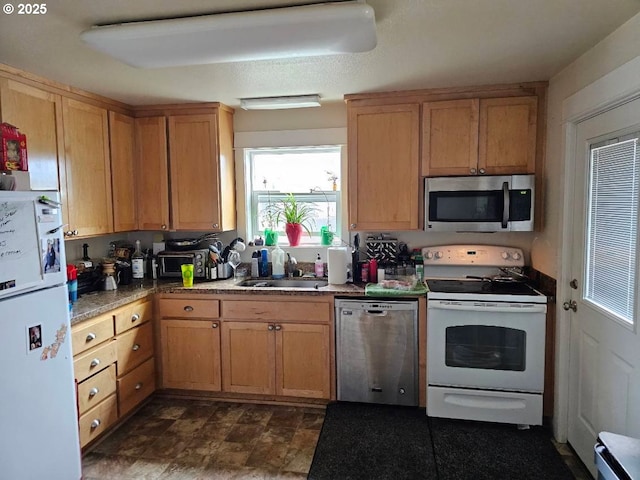 kitchen with appliances with stainless steel finishes and a sink