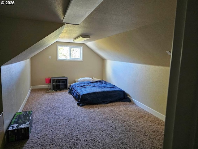 bedroom featuring a textured ceiling, baseboards, carpet flooring, and lofted ceiling