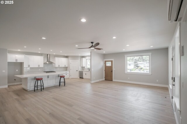 7320 Tanglewood Ave, Gleneden Beach, OR 97388 - living room featuring recessed lighting, light wood-type flooring, ceiling fan, and an AC wall unit