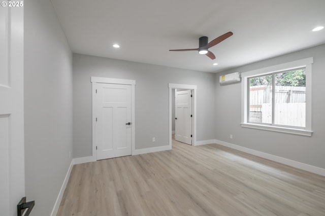 7320 Tanglewood Ave, Gleneden Beach, OR 97388 - empty room featuring light wood-type flooring, ceiling fan, a wall unit AC, and recessed lighting