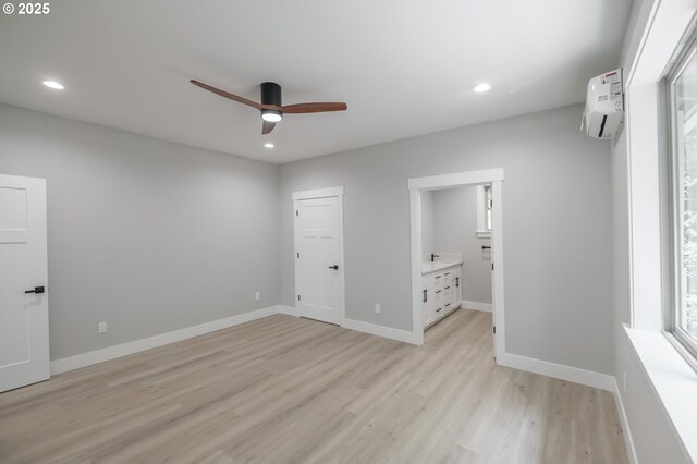 7320 Tanglewood Ave, Gleneden Beach, OR 97388 - unfurnished bedroom with an AC wall unit, light wood-style floors, recessed lighting, ensuite bath, and a ceiling fan