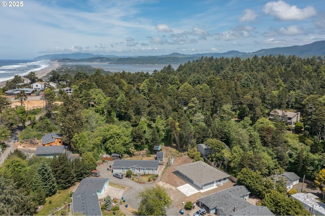 7320 Tanglewood Ave, Gleneden Beach, OR 97388 - aerial overview of property's location featuring a heavily wooded area and a water and mountain view
