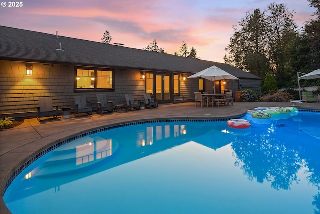 17900 Crestline Dr, Lake Oswego, OR 97034 - pool at dusk featuring an outdoor pool and a patio