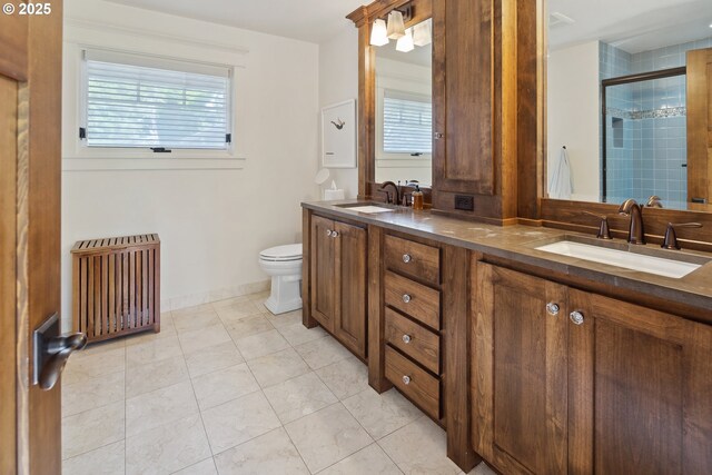 17900 Crestline Dr, Lake Oswego, OR 97034 - bathroom featuring radiator heating unit, double vanity, toilet, a tile shower, and tile patterned floors