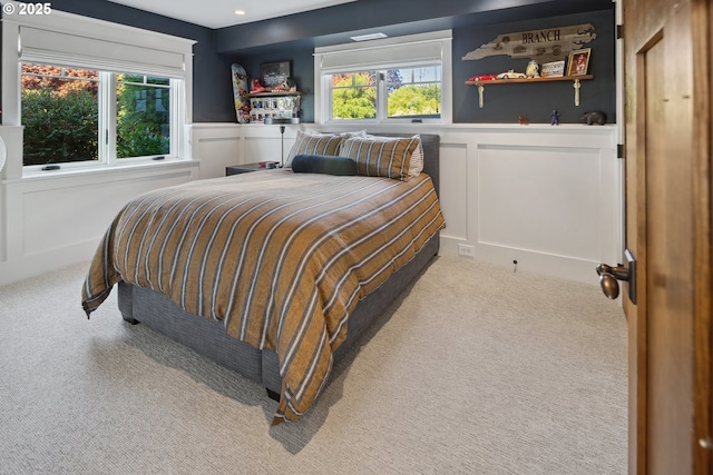 17900 Crestline Dr, Lake Oswego, OR 97034 - bedroom featuring a decorative wall, carpet, multiple windows, and wainscoting