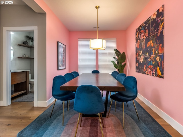 dining room featuring wood finished floors and baseboards