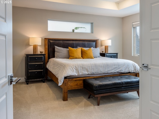 bedroom featuring multiple windows and light carpet