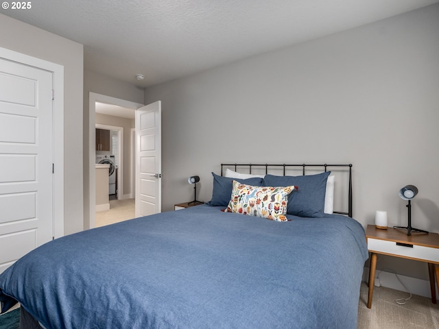 carpeted bedroom with washer / dryer