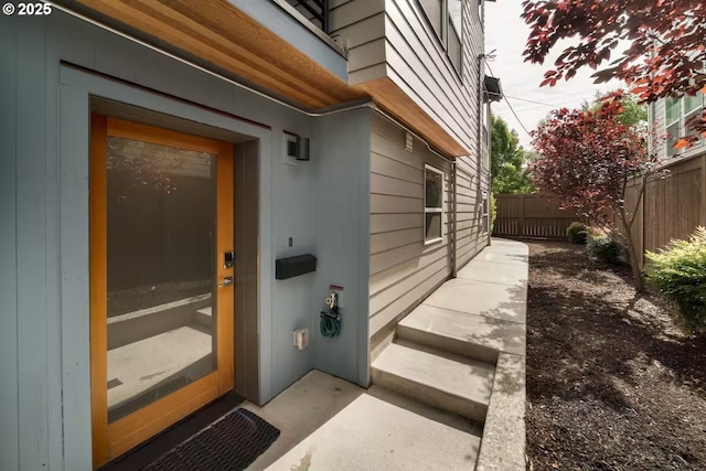 doorway to property with fence