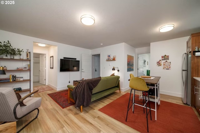 living room featuring light wood-style flooring and baseboards