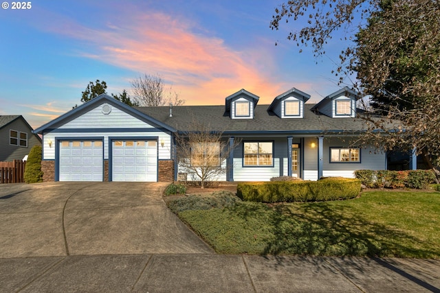 view of front of property with an attached garage, fence, a front lawn, and concrete driveway