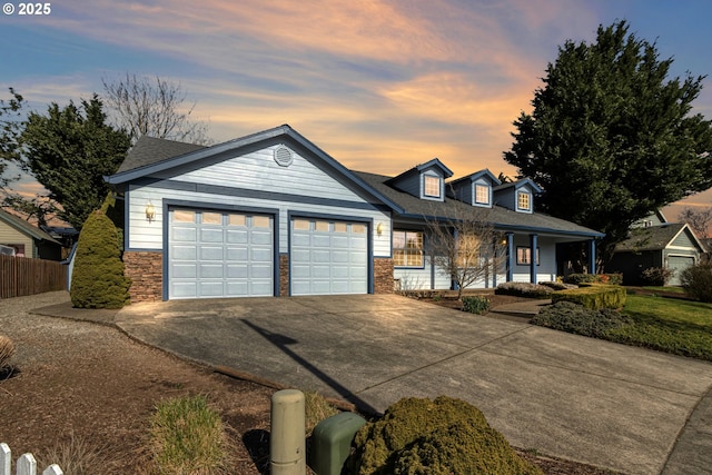 view of front of home with a garage, concrete driveway, stone siding, fence, and a porch