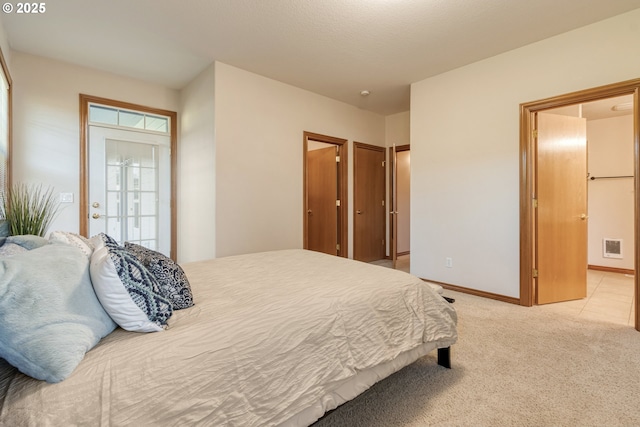 bedroom with light carpet, visible vents, and baseboards