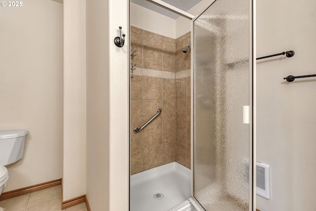 full bath with baseboards, a shower stall, toilet, and tile patterned floors