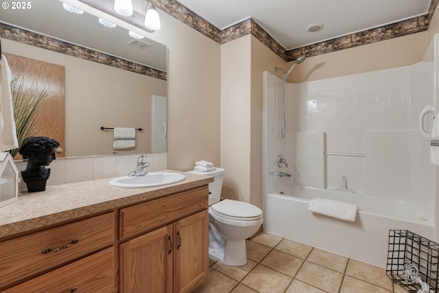 bathroom with visible vents, toilet, tile patterned floors, vanity, and shower / bathing tub combination