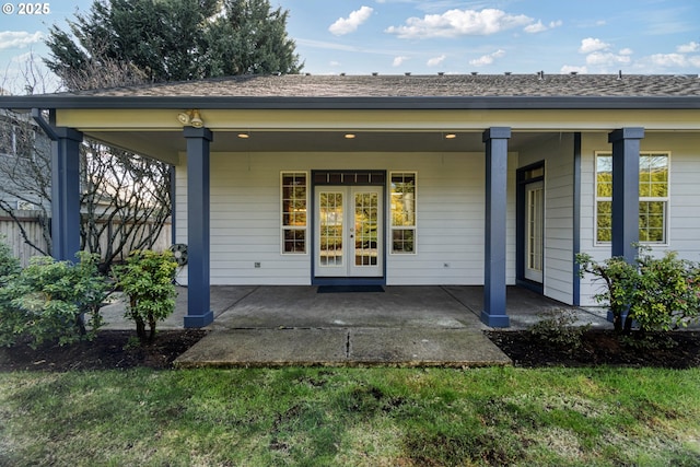 rear view of house featuring french doors and a shingled roof